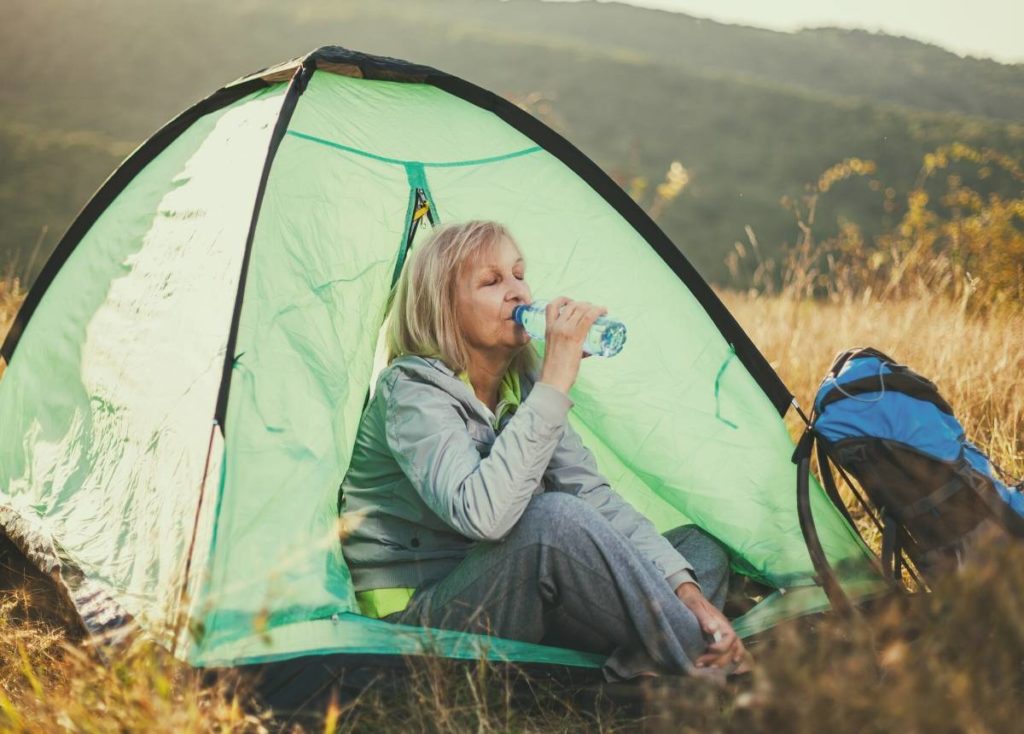 A senior lady camping