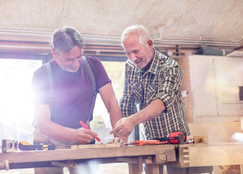 retired men woodworking together