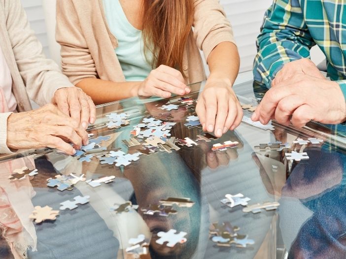 senior citizens putting together a puzzle